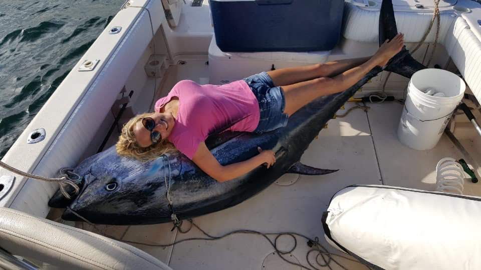 Angler relaxing with a beautiful bluefin in the cockpit